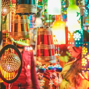 Colorful handmade lanterns at a vibrant festival market showcasing cultural crafts.