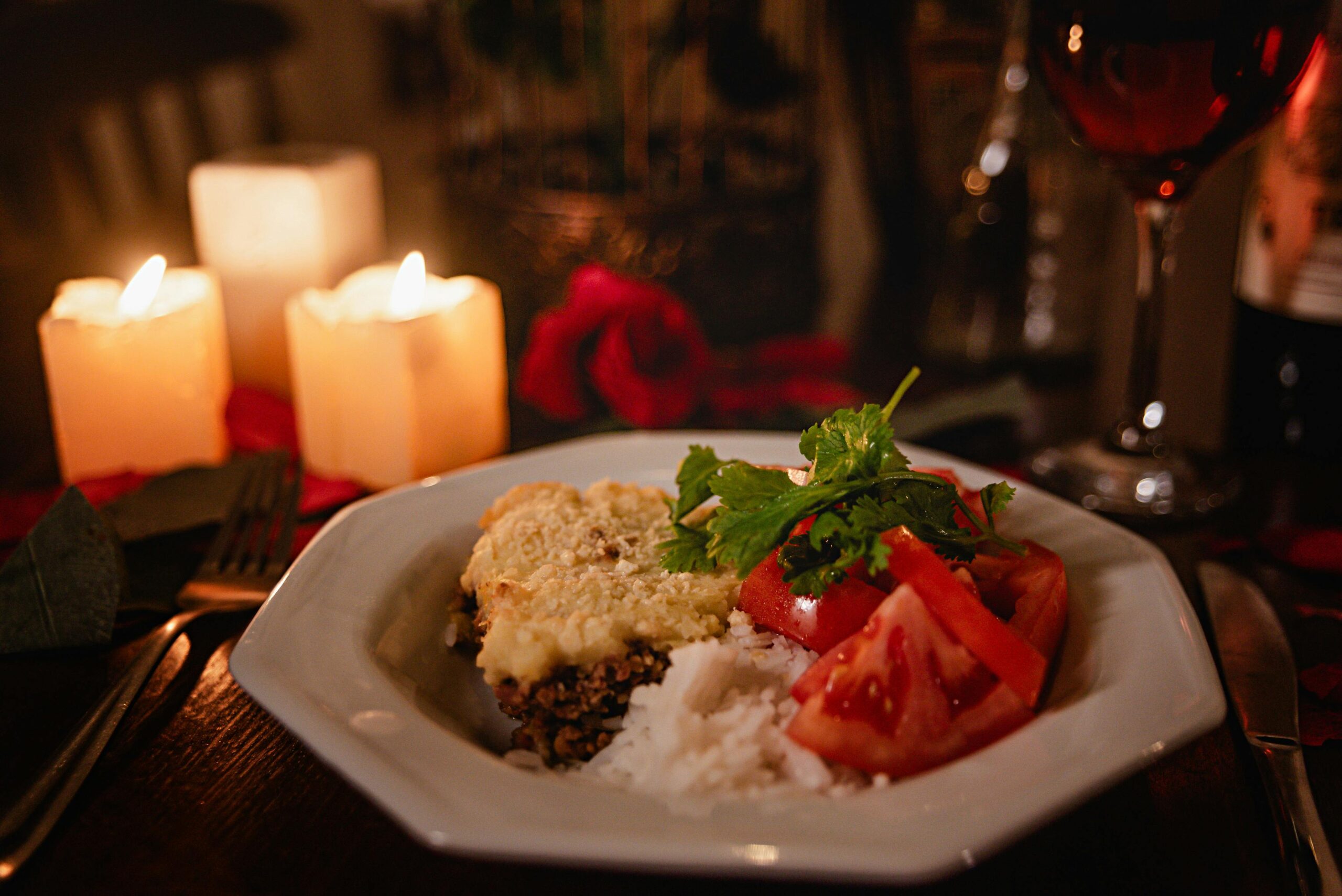pexels photo 19763211 19763211 Cozy dinner setup with a gourmet meal, candles, and wine for a romantic evening.