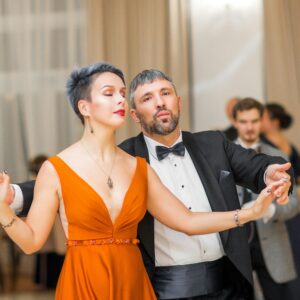 A couple performs a graceful dance at a wedding reception, showcasing elegance and style.