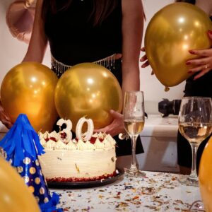 Joyful 30th birthday party with golden balloons, cake, and celebratory drinks.