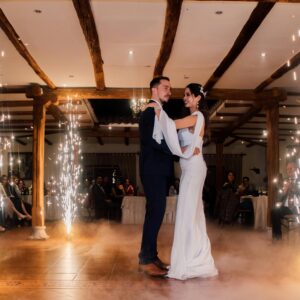 Bride and groom share a magical dance surrounded by indoor fireworks at their wedding reception.