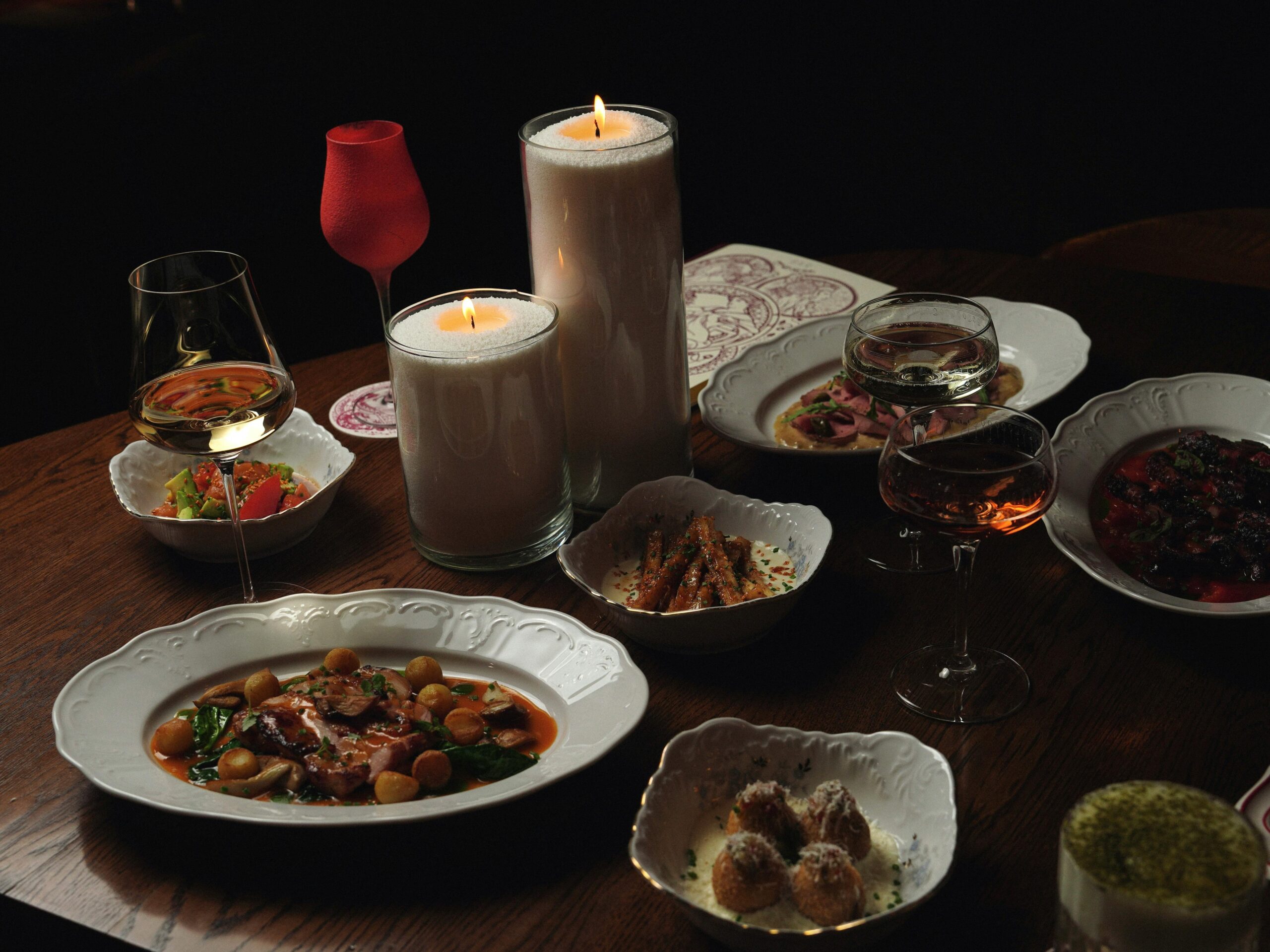 pexels photo 34874927 34874927 A luxurious dining table setup with gourmet dishes and candlelight mood.