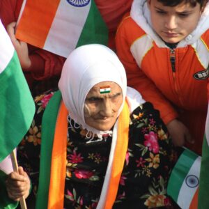 A vibrant gathering celebrating Indian Independence Day with flags.