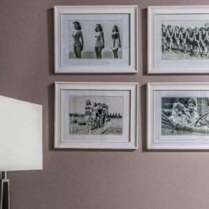 Chic interior wall decor featuring vintage black and white framed nostalgic photos.