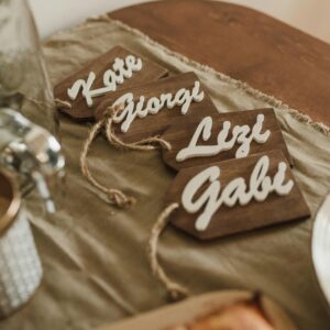 Elegant dining table setup with personalized wooden name tags adding a warm touch to any special occasion.