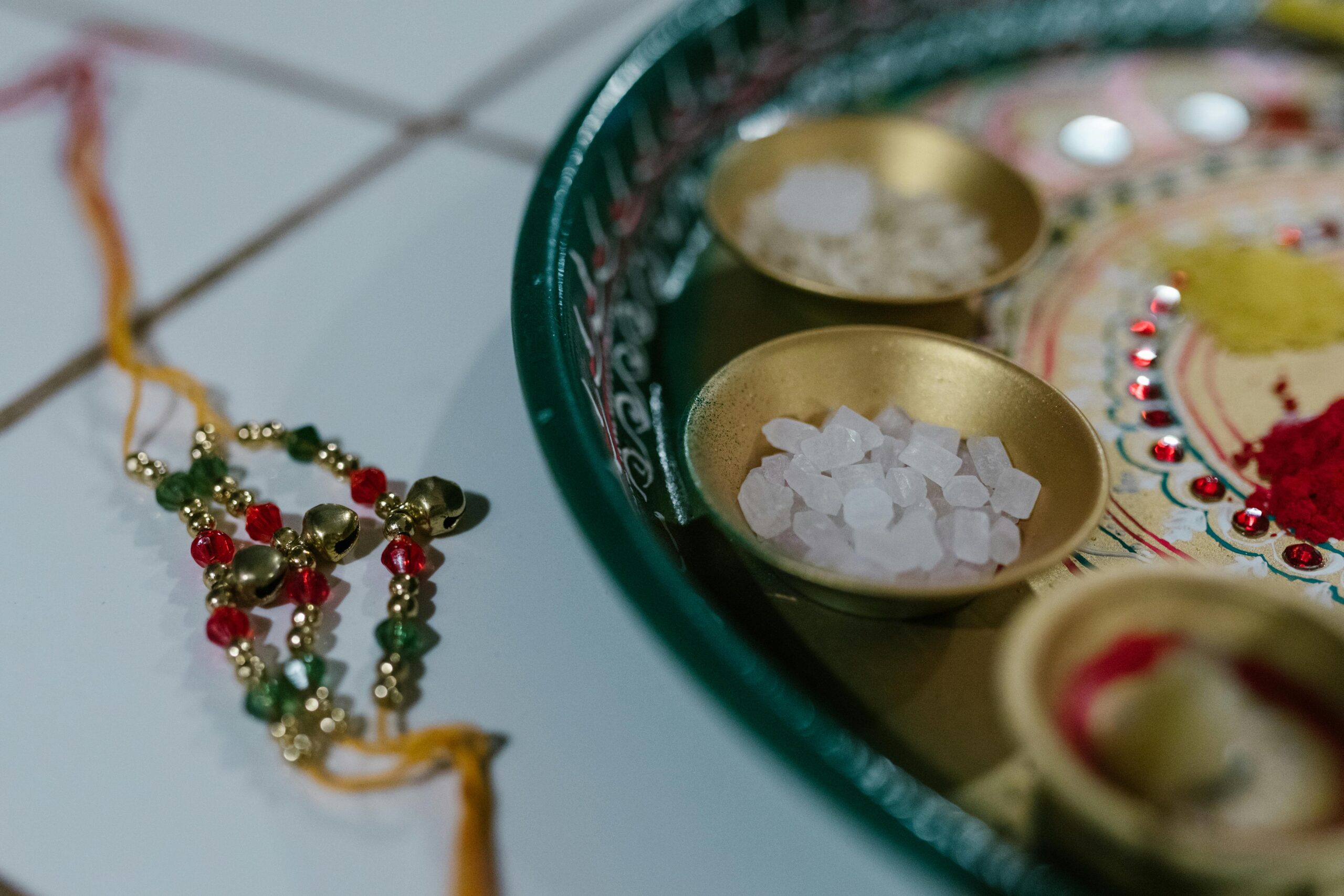 pexels photo 7686249 7686249 Intricate Indian tray featuring rakhi, spices, and decorative elements, symbolizing festive culture.