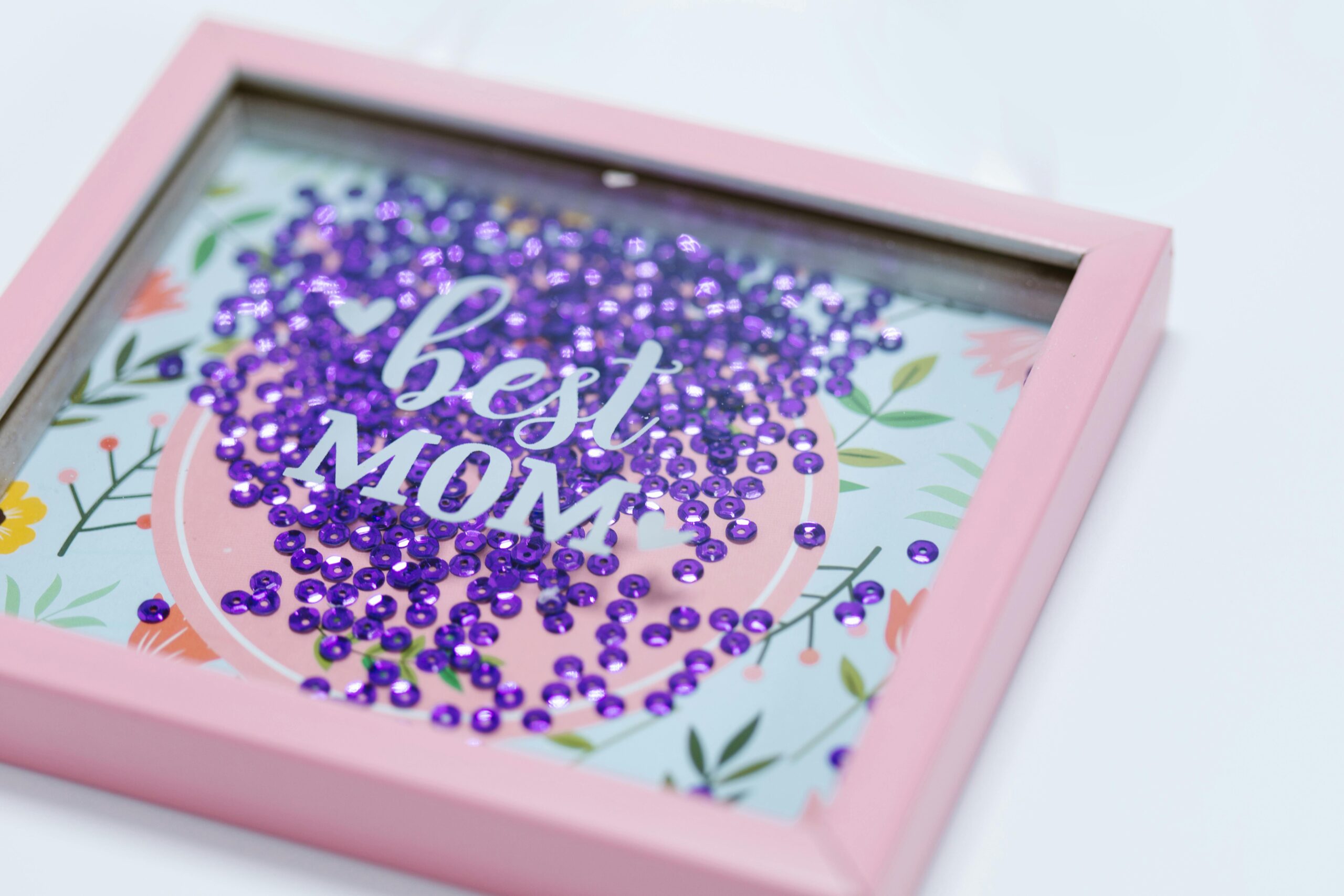 pexels photo 7764459 7764459 Pink shadow box with floral design and sequins, perfect gift for Mother's Day.