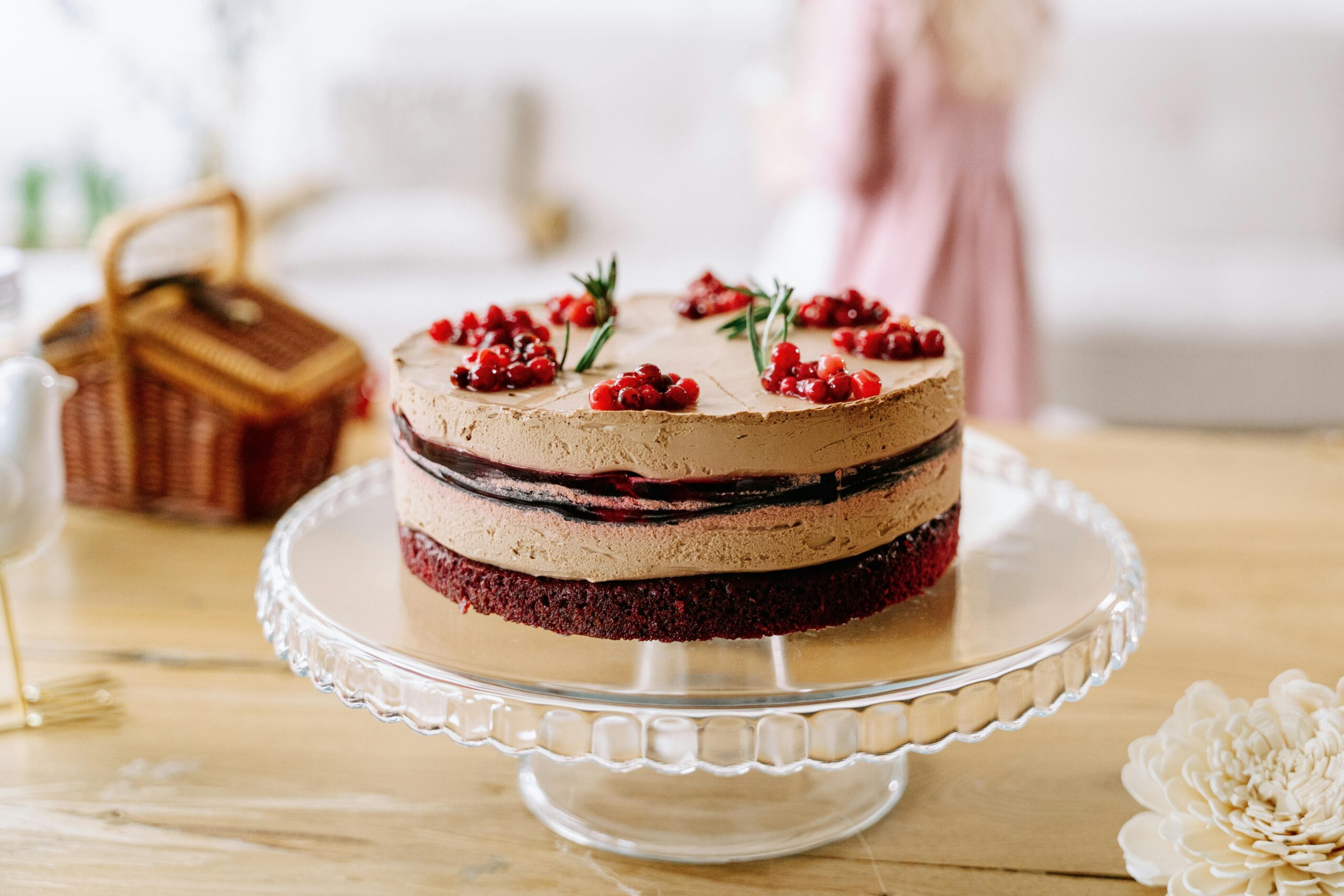 pexels photo 8101695 8101695 1 Delicious chocolate layered cake with berries on a glass stand indoors, perfect for celebrations.